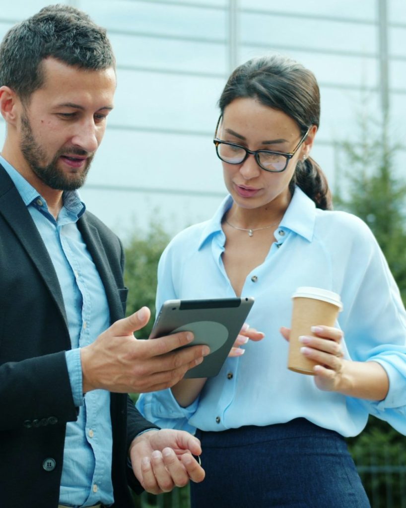 HR Alliance specialists reviewing plans on a tablet